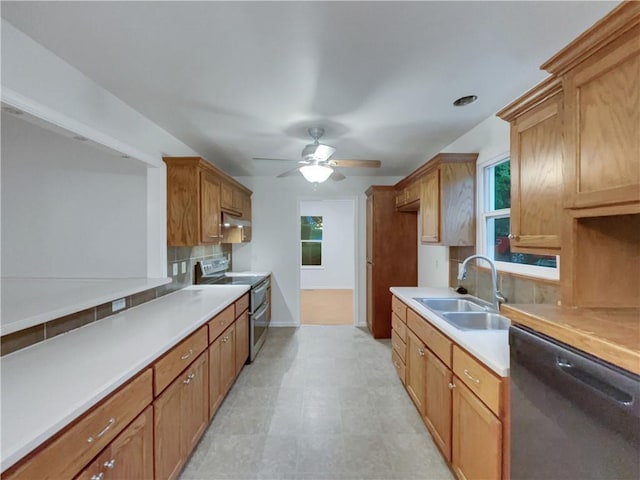 131 Brookridge St, Lansing, KS 66043 - kitchen with stainless steel appliances, a sink, tasteful backsplash, ceiling fan, and light countertops