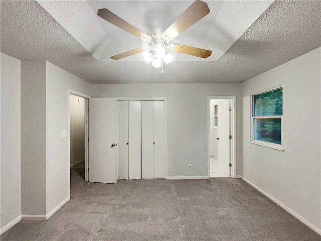 131 Brookridge St, Lansing, KS 66043 - unfurnished bedroom featuring carpet flooring, a textured ceiling, baseboards, a closet, and ceiling fan