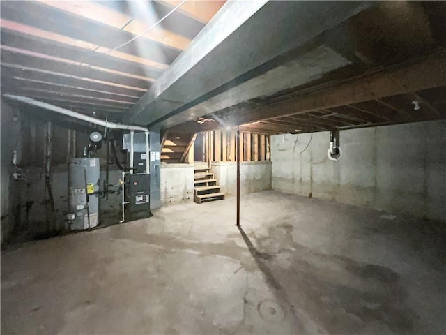 131 Brookridge St, Lansing, KS 66043 - unfinished below grade area featuring water heater, stairs, and heating unit