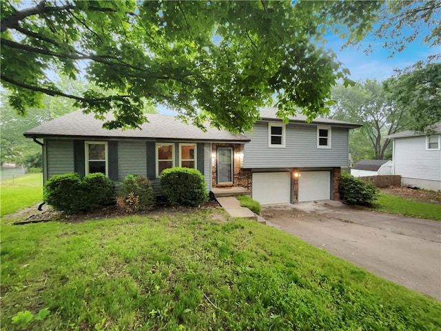 131 Brookridge St, Lansing, KS 66043 - split level home featuring an attached garage, driveway, and a front lawn
