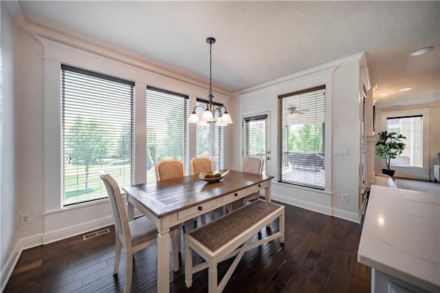 9101 W 158th St, Overland Park, KS 66221 - dining area with baseboards, dark wood-style flooring, ornamental molding, a chandelier, and healthy amount of natural light
