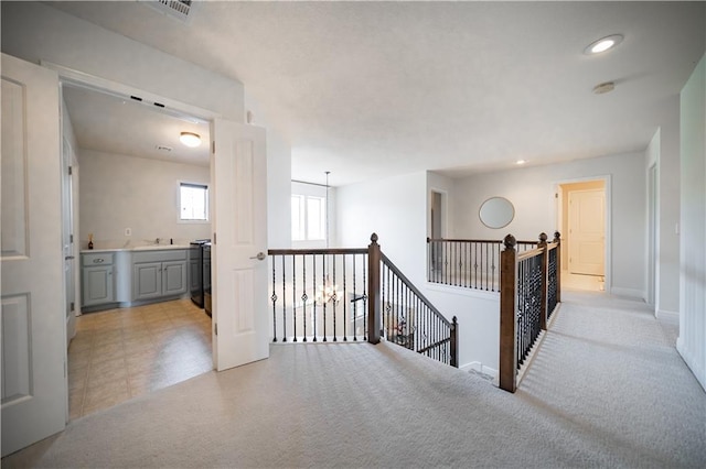 9101 W 158th St, Overland Park, KS 66221 - corridor featuring an upstairs landing, a sink, recessed lighting, light colored carpet, and baseboards
