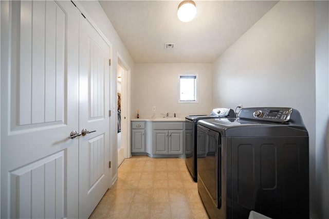 9101 W 158th St, Overland Park, KS 66221 - laundry area with washing machine and clothes dryer and cabinet space