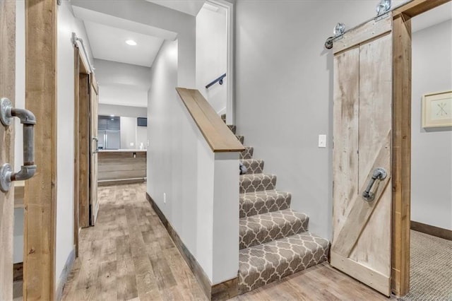 9101 W 158th St, Overland Park, KS 66221 - staircase featuring wood finished floors, baseboards, and a barn door