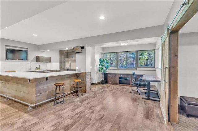 9101 W 158th St, Overland Park, KS 66221 - kitchen featuring stainless steel fridge with ice dispenser, wood finished floors, an office area, recessed lighting, and a kitchen breakfast bar