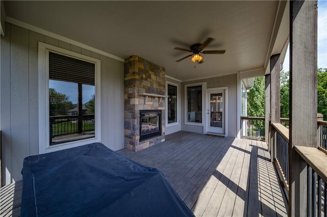 9101 W 158th St, Overland Park, KS 66221 - wooden deck with an outdoor stone fireplace and a ceiling fan