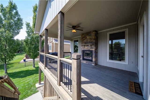9101 W 158th St, Overland Park, KS 66221 - wooden terrace with an outdoor stone fireplace and ceiling fan