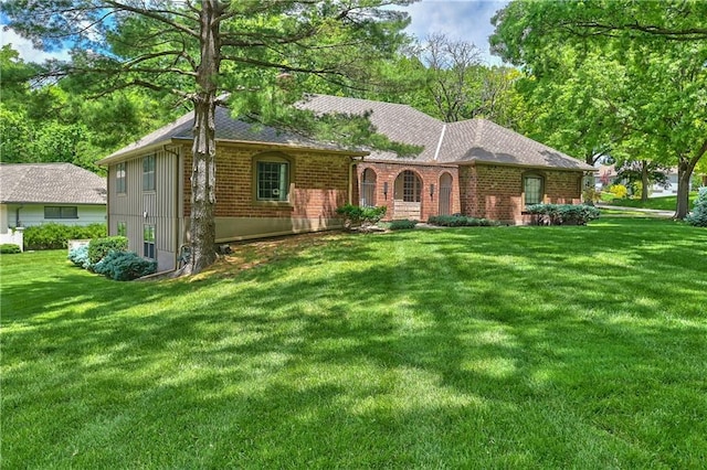 12614 Ensley Ln, Leawood, KS 66209 - ranch-style home with brick siding, a front lawn, and roof with shingles