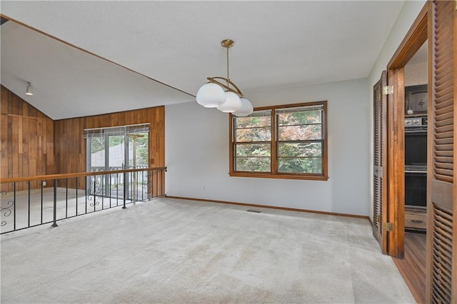 12614 Ensley Ln, Leawood, KS 66209 - unfurnished room with baseboards, wooden walls, carpet, and vaulted ceiling
