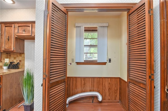 12614 Ensley Ln, Leawood, KS 66209 - hall with a wainscoted wall, wooden walls, and light wood-type flooring