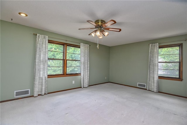 12614 Ensley Ln, Leawood, KS 66209 - unfurnished room featuring healthy amount of natural light, ceiling fan, light colored carpet, and baseboards