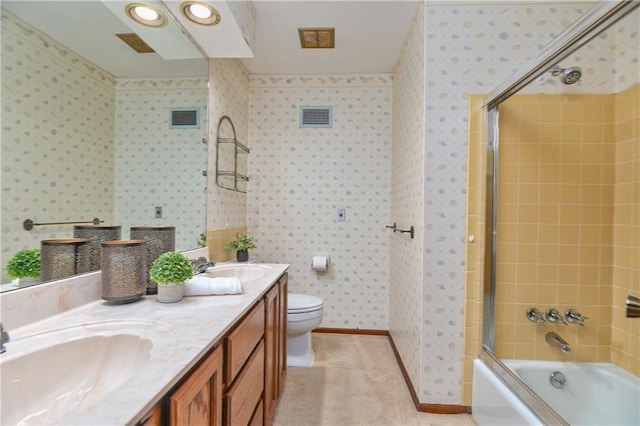 12614 Ensley Ln, Leawood, KS 66209 - bathroom with double vanity, toilet, bath / shower combo with glass door, and wallpapered walls