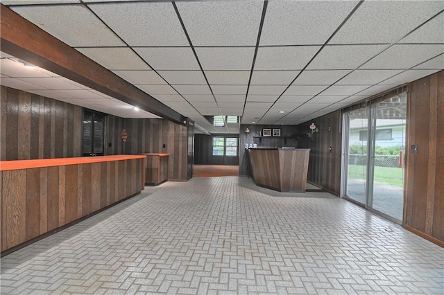 12614 Ensley Ln, Leawood, KS 66209 - indoor bar featuring wooden walls, brick patterned flooring, baseboards, and a paneled ceiling