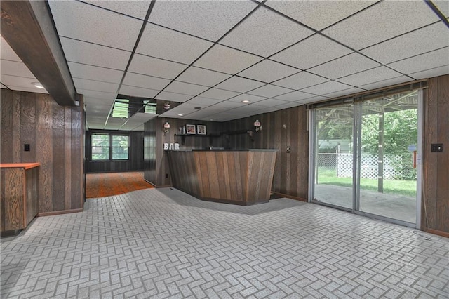 12614 Ensley Ln, Leawood, KS 66209 - reception with wooden walls, bar area, and a paneled ceiling