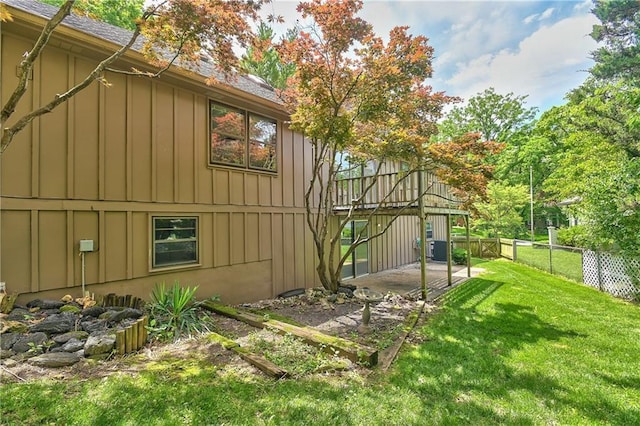 12614 Ensley Ln, Leawood, KS 66209 - view of property exterior with board and batten siding, a patio area, cooling unit, and roof with shingles