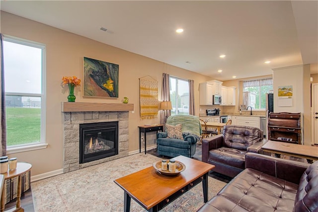 214 N Mcgee St, Tonganoxie, KS 66086 - living area featuring recessed lighting, baseboards, and a fireplace