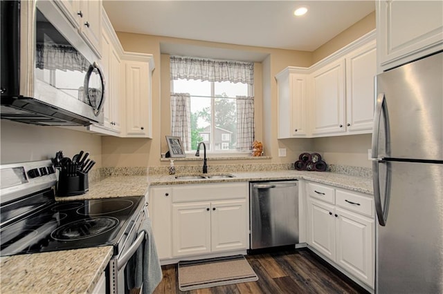 214 N Mcgee St, Tonganoxie, KS 66086 - kitchen with appliances with stainless steel finishes, a sink, white cabinetry, dark wood-style flooring, and recessed lighting