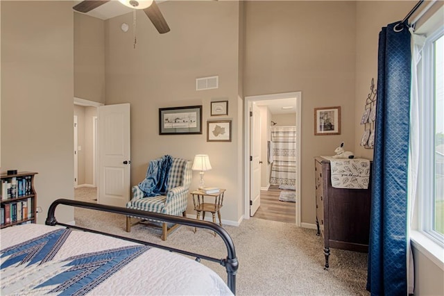 214 N Mcgee St, Tonganoxie, KS 66086 - carpeted bedroom with a towering ceiling, baseboards, and ensuite bathroom