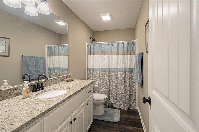 214 N Mcgee St, Tonganoxie, KS 66086 - full bath featuring wood finished floors, toilet, vanity, and a shower with shower curtain