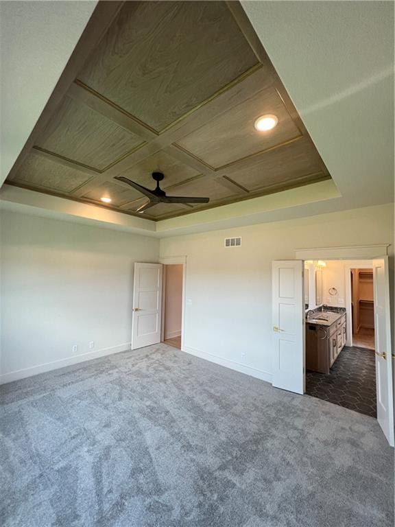 16311 Mustang St, Gardner, KS 66030 - empty room featuring dark carpet, ceiling fan, baseboards, coffered ceiling, and recessed lighting
