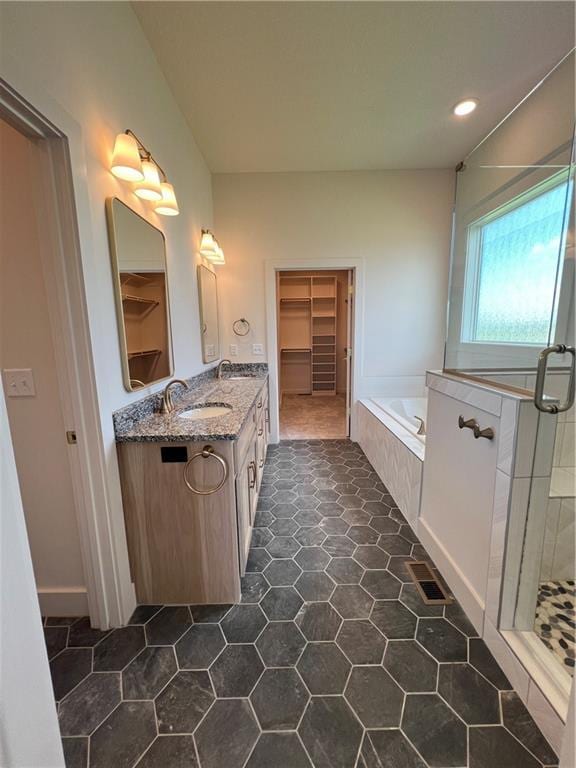 16311 Mustang St, Gardner, KS 66030 - bathroom featuring vanity, a stall shower, a bath, a walk in closet, and tile patterned floors