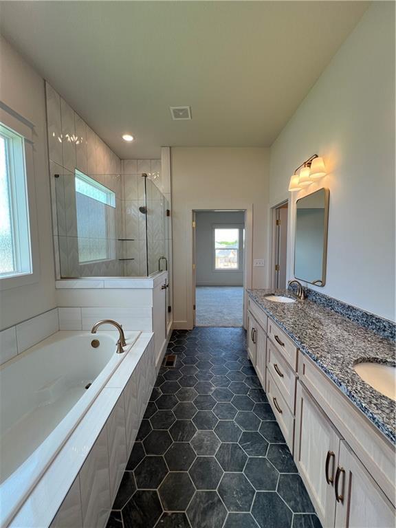 16311 Mustang St, Gardner, KS 66030 - full bath with a shower stall, double vanity, a garden tub, and recessed lighting