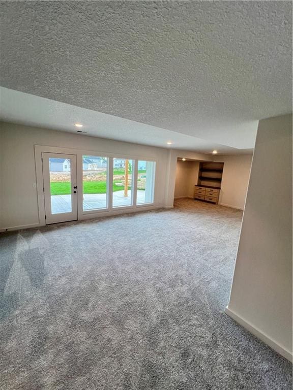 16311 Mustang St, Gardner, KS 66030 - unfurnished living room with a textured ceiling, carpet floors, recessed lighting, and baseboards