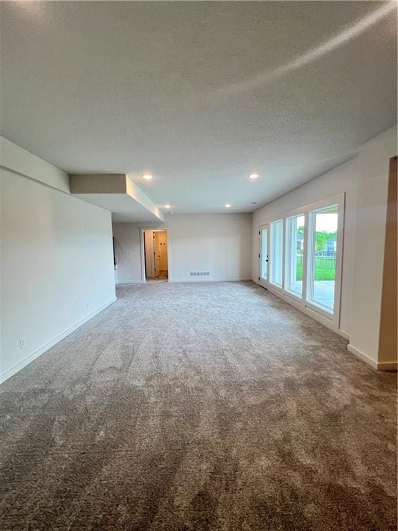 16311 Mustang St, Gardner, KS 66030 - unfurnished living room featuring carpet, baseboards, a textured ceiling, and recessed lighting