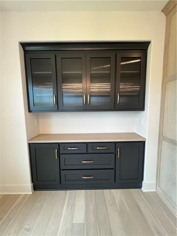 16311 Mustang St, Gardner, KS 66030 - bar area featuring light wood-type flooring and baseboards