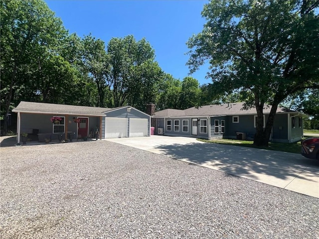 344 E 520th Ave, Pittsburg, KS 66762 - single story home featuring driveway, an outbuilding, and an attached garage