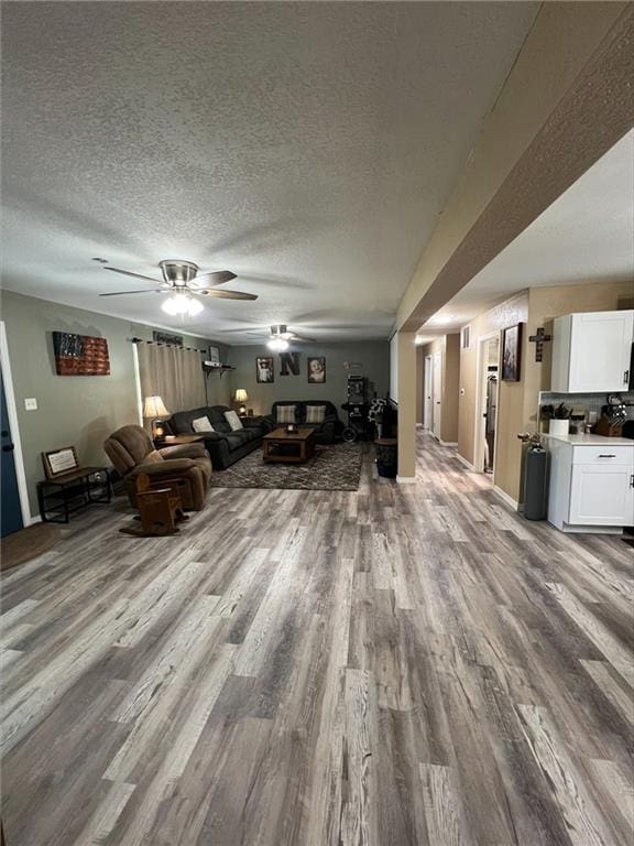 344 E 520th Ave, Pittsburg, KS 66762 - living area with a ceiling fan, wood finished floors, and a textured ceiling