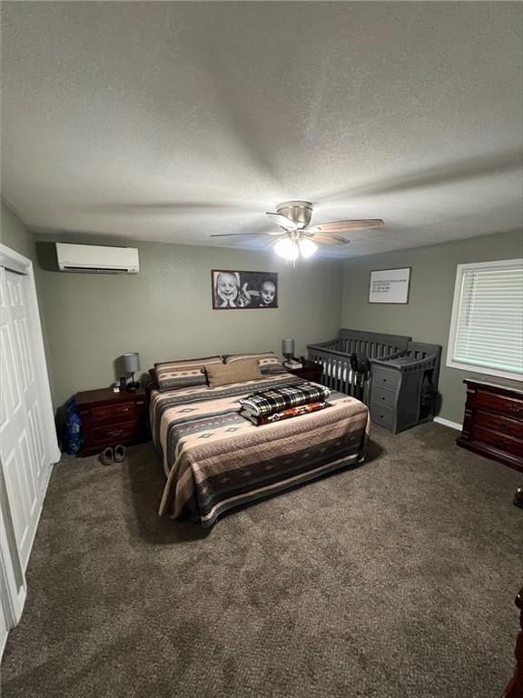 344 E 520th Ave, Pittsburg, KS 66762 - carpeted bedroom with a textured ceiling, a wall mounted air conditioner, a ceiling fan, and a closet