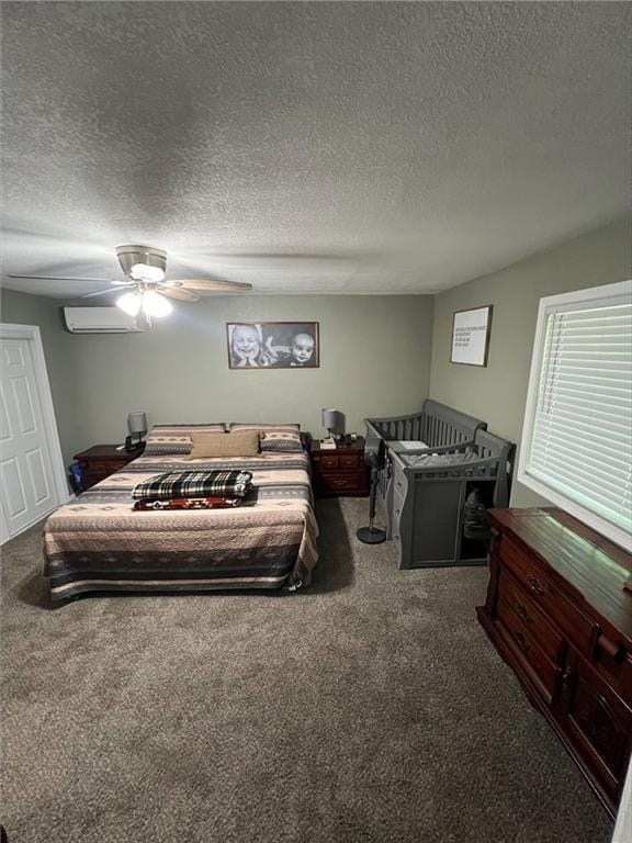 344 E 520th Ave, Pittsburg, KS 66762 - bedroom featuring carpet flooring, a wall unit AC, a ceiling fan, and a textured ceiling