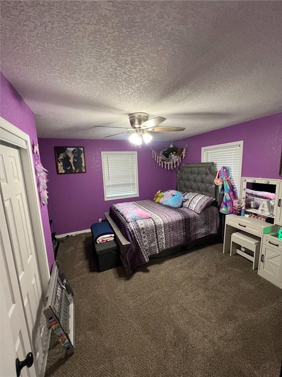 344 E 520th Ave, Pittsburg, KS 66762 - carpeted bedroom featuring a textured ceiling and a ceiling fan