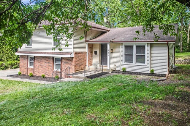 12309 Askew Dr, Grandview, MO 64030 - tri-level home featuring brick siding, a front lawn, and roof with shingles