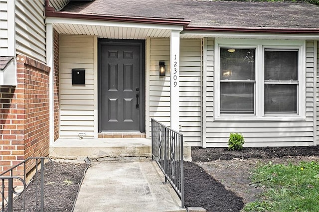 12309 Askew Dr, Grandview, MO 64030 - entrance to property with covered porch and roof with shingles