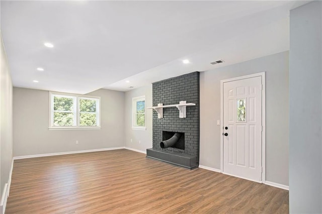 12309 Askew Dr, Grandview, MO 64030 - unfurnished living room featuring light wood-type flooring, baseboards, a fireplace, and recessed lighting