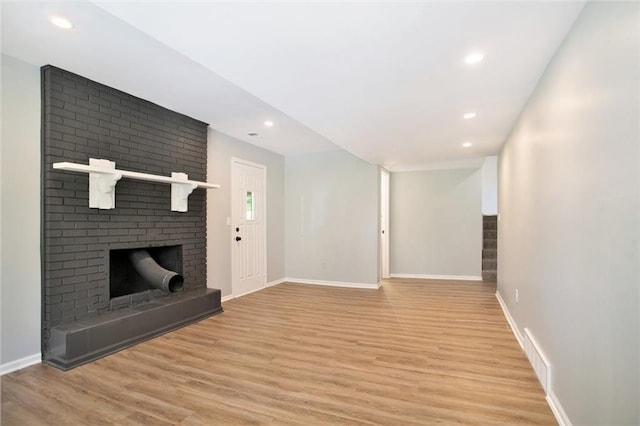 12309 Askew Dr, Grandview, MO 64030 - unfurnished living room with light wood-style floors, a fireplace, baseboards, and recessed lighting