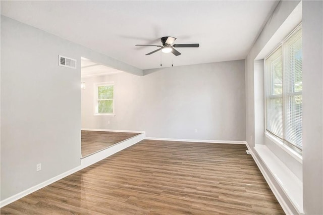 12309 Askew Dr, Grandview, MO 64030 - spare room with baseboards, wood finished floors, and ceiling fan