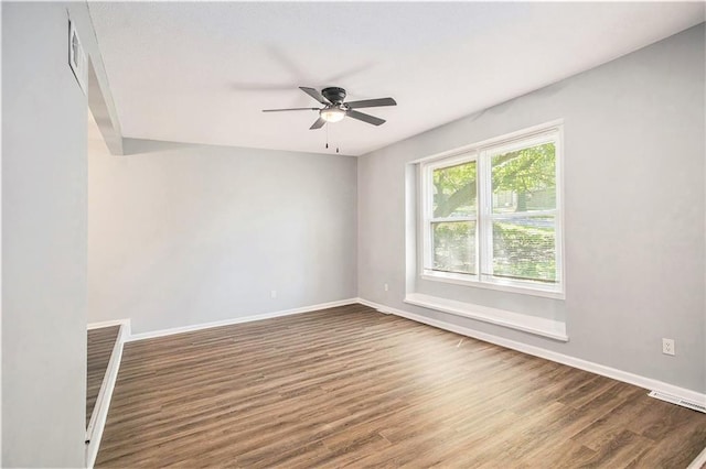 12309 Askew Dr, Grandview, MO 64030 - empty room featuring a ceiling fan, wood finished floors, and baseboards