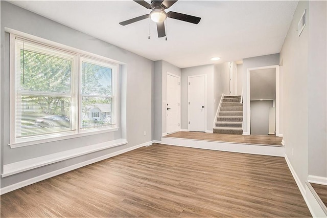 12309 Askew Dr, Grandview, MO 64030 - empty room with baseboards, healthy amount of natural light, and wood finished floors