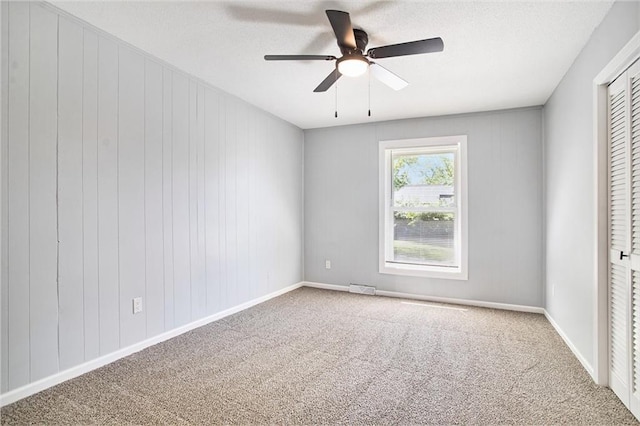 12309 Askew Dr, Grandview, MO 64030 - carpeted empty room with a ceiling fan