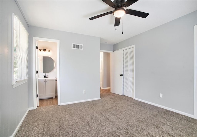 12309 Askew Dr, Grandview, MO 64030 - unfurnished bedroom with carpet flooring, baseboards, a closet, connected bathroom, and ceiling fan
