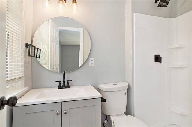 12309 Askew Dr, Grandview, MO 64030 - bathroom featuring vanity, a shower, and toilet