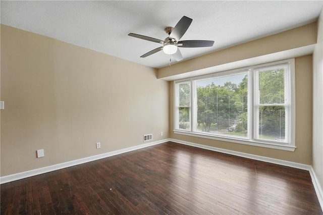 10217 Wheeling Ave, Kansas City, MO 64134 - empty room with baseboards, ceiling fan, and dark wood-style flooring