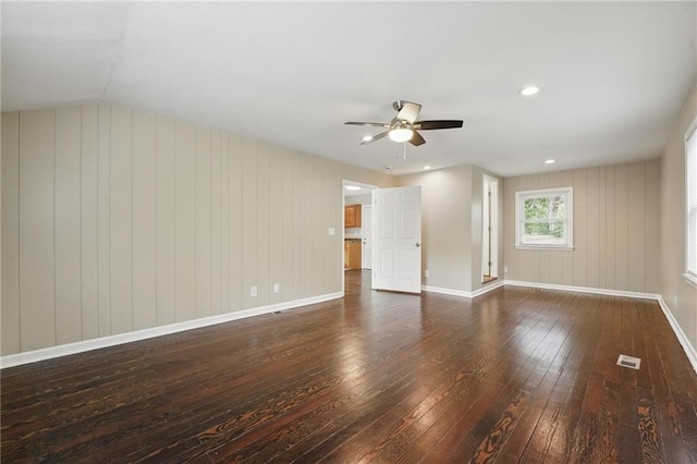 10217 Wheeling Ave, Kansas City, MO 64134 - unfurnished living room featuring wood-type flooring, a ceiling fan, baseboards, and vaulted ceiling