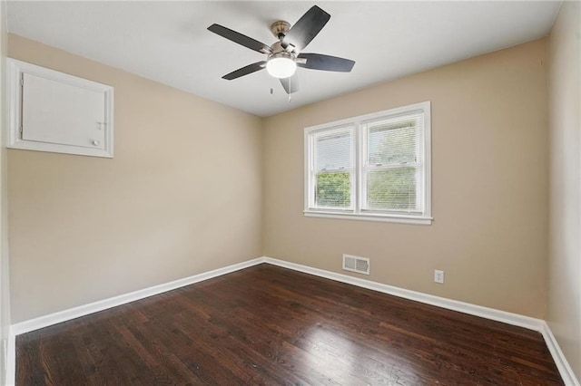 10217 Wheeling Ave, Kansas City, MO 64134 - empty room with baseboards, dark wood-type flooring, and a ceiling fan