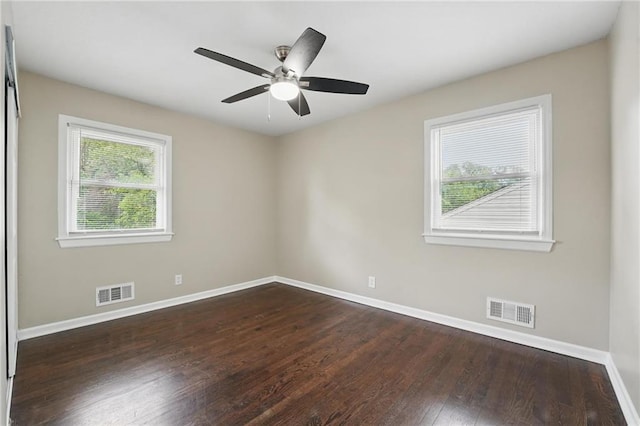 10217 Wheeling Ave, Kansas City, MO 64134 - unfurnished room featuring baseboards, dark wood-type flooring, and ceiling fan