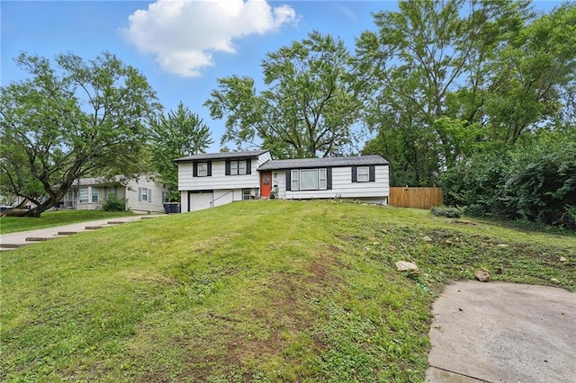 10217 Wheeling Ave, Kansas City, MO 64134 - tri-level home featuring a garage