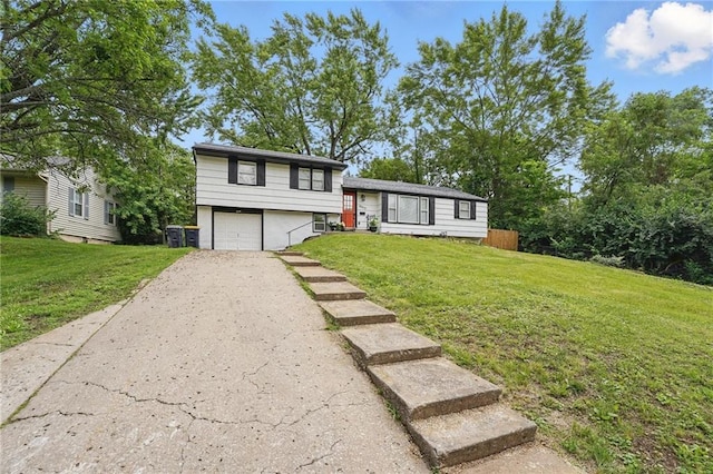 10217 Wheeling Ave, Kansas City, MO 64134 - tri-level home with driveway, an attached garage, and a front lawn